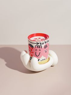 a coffee cup sitting on top of a saucer shaped like an elephant with hearts