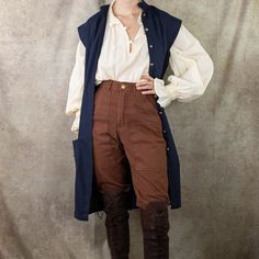 This cotton linen vest is inspired by 18th century waistcoasts and medieval surcoats. Made with rich linen fabric, this tunic vest is the perfect layer for completing a pirate, knight, captain, prince charming, or historical gentleman costume. Layer it over one of our Darcy Shirts with our Wide Leather Waist Belt to complete the look. This unisex piece is versatile and timeless, and perfect for both men's and women's renaissance faire costumes. Mens Pirate Outfit, Pirate Vest, 1700s Pirate Fashion, Authentic Pirate Clothing, Modern Fantasy Clothing, Real Pirate Clothes, Sleeveless Pirate Coat, Pirate Undershirt, Yellow Corset