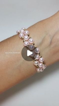 a woman's arm wearing a bracelet with pearls