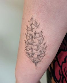 a pineapple tattoo on the right arm