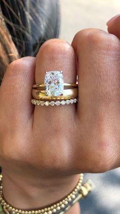 a close up of a person's hand with a ring on their finger and a diamond in the middle