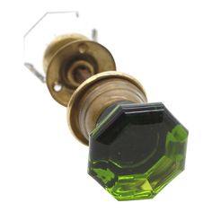 a green glass door knob on a white background with the top part of it missing