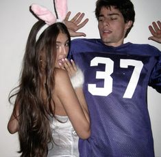 a man and woman in bunny ears standing next to each other