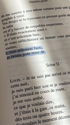 an open book with french writing on it and the words written in blue are highlighted