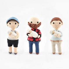 three crocheted figurines, one with a beard and the other holding a baby