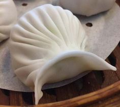 some dumplings sitting on top of a wooden tray