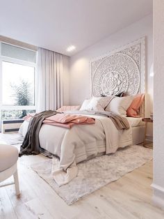 a bedroom with a large bed and white walls