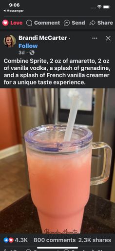 a pink drink with a straw in it sitting on top of a counter