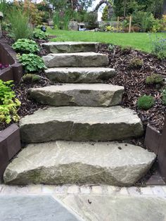 stone steps lead up to the front yard