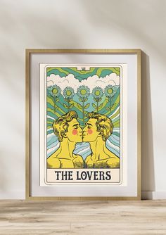 the lovers tarot card art print in a wooden frame on a wall above a table