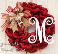 a red wreath with the letter m on it