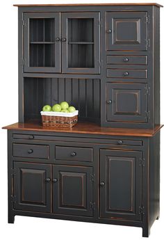 an old style hutch with fruit on top