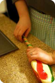 a person is holding a toothbrush in their hand while sitting at a counter top