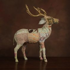 a paper mache sculpture of a deer with antlers