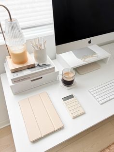 an apple computer sitting on top of a white desk next to a keyboard and mouse