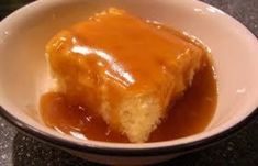 a piece of cake with caramel sauce in a bowl