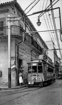 an old photo of a trolley on the street