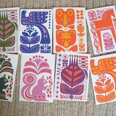 six cards with different designs on them sitting next to each other in front of a carpet