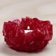 a red candle that is sitting on a table