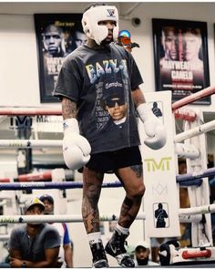 a man with tattoos and boxing gloves on