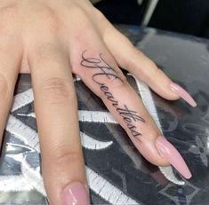 a woman's hand with a tattoo on it that says, love is all you need