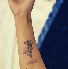 a woman's wrist with a tattoo saying no matter, no flowers on it