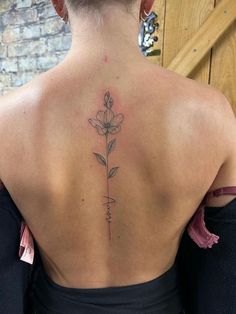 a woman with a flower tattoo on her back