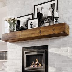 a white brick fireplace with pictures on the mantle