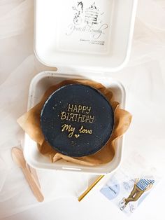 a birthday cake in a box with writing on it