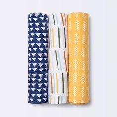 three napkins in different colors and patterns on a white background, each with an arrow design