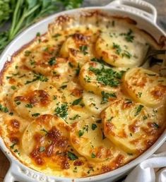 a casserole dish with potatoes and parsley