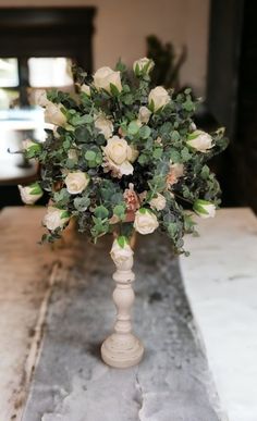 a vase filled with white flowers on top of a table