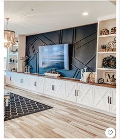 a living room filled with furniture and a flat screen tv on top of a wooden entertainment center