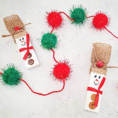 some christmas decorations made out of toilet paper rolls and burlocks with red pom - poms on them