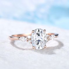 an oval cut diamond ring with three side stones