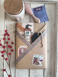 the contents of a crafting kit laid out on a white wooden surface next to a potted plant