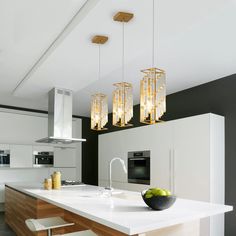 a modern kitchen with white counter tops and wooden accents on the ceiling, along with hanging lights over the island