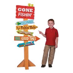 a young boy standing next to a wooden sign with many signs on it that say gone fishin