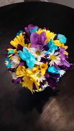 a bouquet of flowers sitting on top of a wooden table