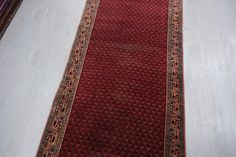 a red rug is laying on the floor