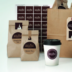 a coffee cup and some brown bags on a table