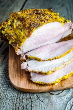 sliced ham sitting on top of a wooden cutting board