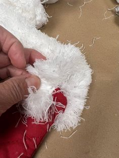 someone is working on something with white yarn