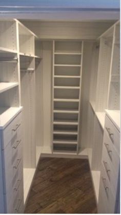 an empty walk in closet with shelves and drawers