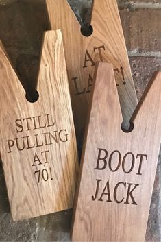 three wooden tags that say still pulling at boot jack