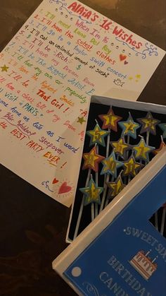 a bunch of birthday candles with writing on them sitting next to a card and envelope