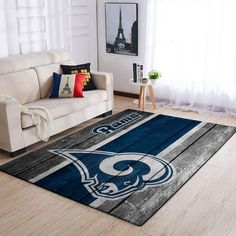 a living room area with a couch, chair and rug in the shape of a hockey team