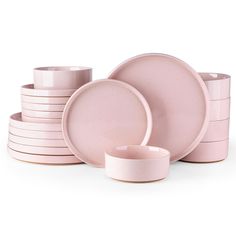 pink dishes and cups are stacked on top of each other, with one bowl in the middle