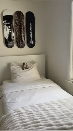 a bed with two skateboards mounted to the wall above it and another pillow on top