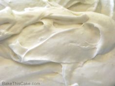 a close up view of white frosting on a cake